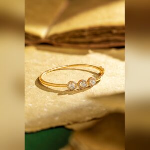Gold bangle with three diamond halo motifs by Sri Sai Krishna Jewellers