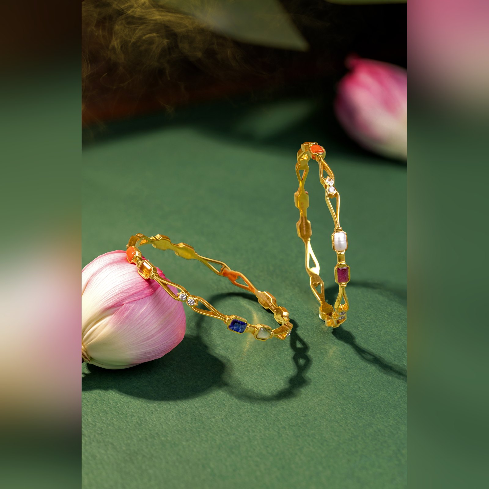 Pair of gold bangles set with navratna multi gemstones by Sri Sai Krishna Jewellers